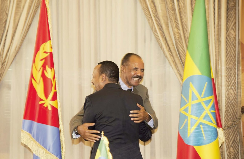 ETHIOPIA’S PRIME Minister Abiy Ahmed and Eritrean President Isaias Afwerk embrace at the declaration signing in Asmara, Eritrea on July 9. (photo credit: REUTERS)