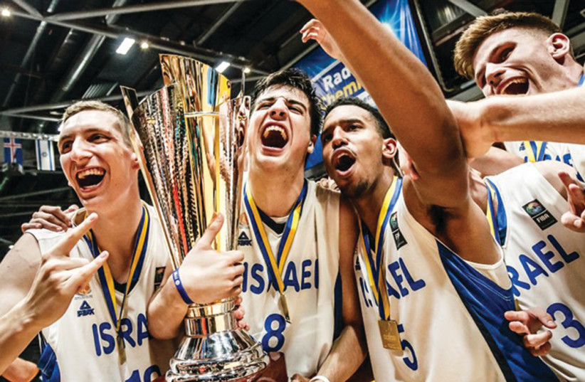ISRAELI PLAYERS celebrate withtrophyfollowing victory over Croatia in final2018 FIBA Under-20 European Championship in Chemnitz, Germany, 2018 (photo credit: FIBA EUROPE/ COURTESY)