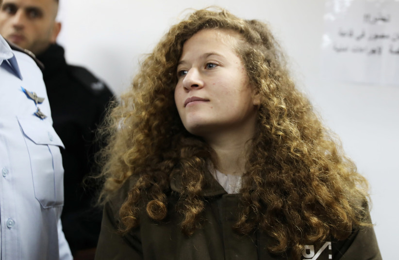 Palestinian teen Ahed Tamimi enters a military courtroom at Ofer Prison, near the West Bank city of Ramallah, January 15, 2018 (photo credit: AMMAR AWAD / REUTERS)