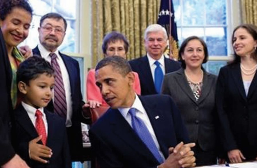 PRESIDENT BARACK Obama signs the Daniel Pearl Freedom of the Press Act surrounded by the late journalist’s family at the White House in 2010. (photo credit: COURTESY PEARL FAMILY)