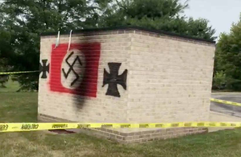 Swastika graffiti is seen painted at the Jewish Synagogue, Congregation Shaarey Tefilla, in Carmel, Indiana, U.S. July 29, 2018 in this still image taken from a video obtained from social media on July 30, 2018 (photo credit: FACEBOOK/ROGER COOPER/VIA REUTERS)