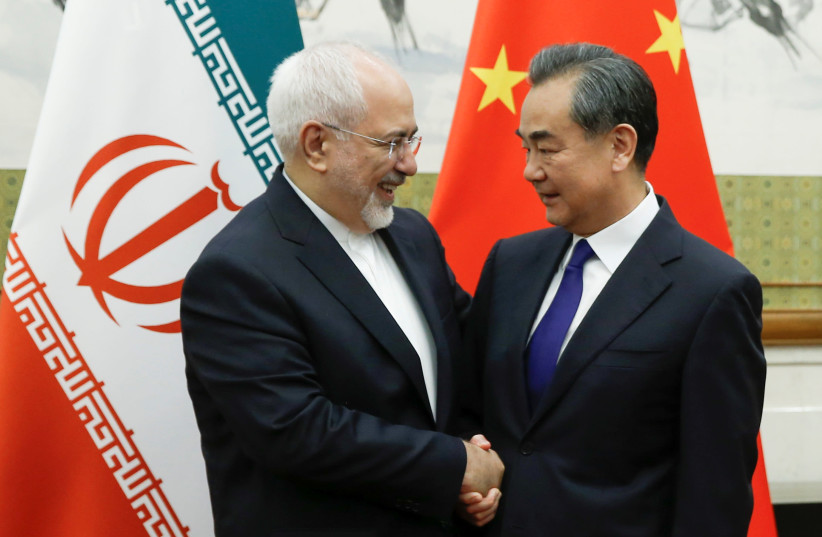 Chinese State Councillor and Foreign Minister Wang Yi meets Iranian Foreign Minister Mohammad Javad Zarif at Diaoyutai state guesthouse in Beijing, China May 13, 2018 (photo credit: THOMAS PETER/REUTERS)