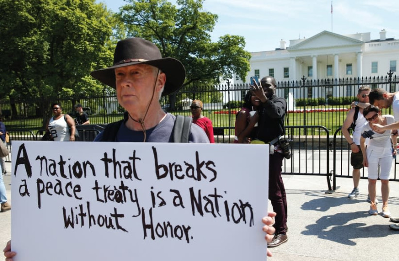 A PROTESTER makes his feelings known outside the White House as President Donald Trump announced the US withdrawal from the Iran deal, in Washington on May 8, 2018 (photo credit: REUTERS)