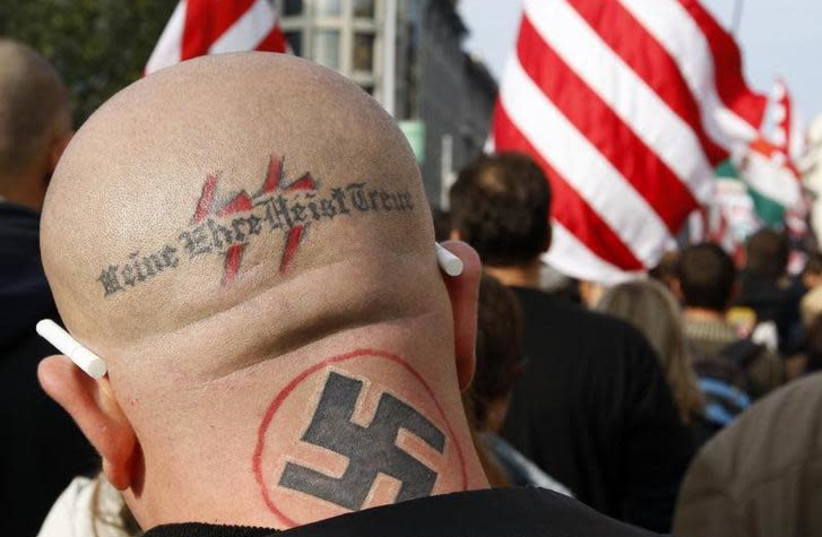 A neo Nazi attends a rally in Budapest October 23, 2009. The words, the motto of the S.S., read "my honor is my loyalty" (photo credit: LASZIO BALOGH/REUTERS)