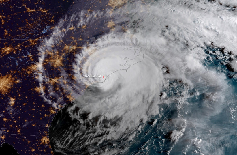 Hurricane Florence is shown from a National Oceanic and Atmospheric Administration (NOAA) #GOESEast satellite shortly after the storm made landfall near Wrightsville Beach, North Carolina, U.S., September 14, 2018. (photo credit: REUTERS)