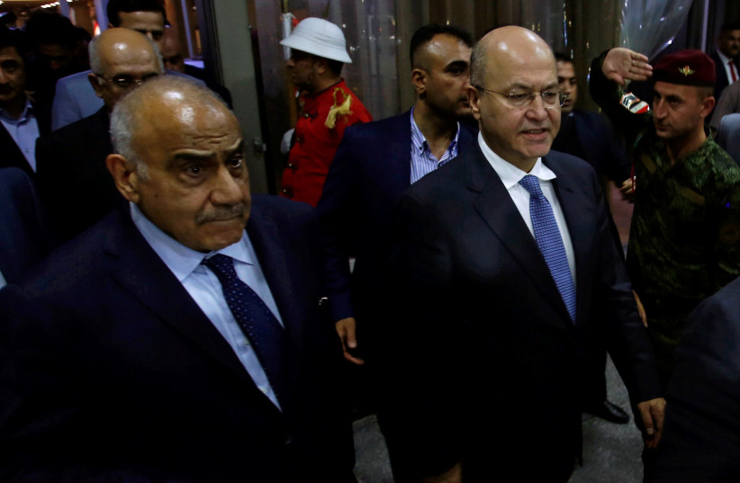 Barham Salih, Iraq's newly elected president, walks with Iraq's new Prime Minister Adel Abdul Mahdi at the parliament headquarters, in Baghdad, Iraq October 2, 2018.  (photo credit: REUTERS/KHALID AL MOUSILY)