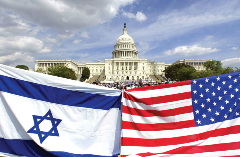 AMERICAN AND ISRAELI flags fly during a demonstration in support of Israel at the US Capitol in 2002. (photo credit: KEVIN LAMARQUE/REUTERS)