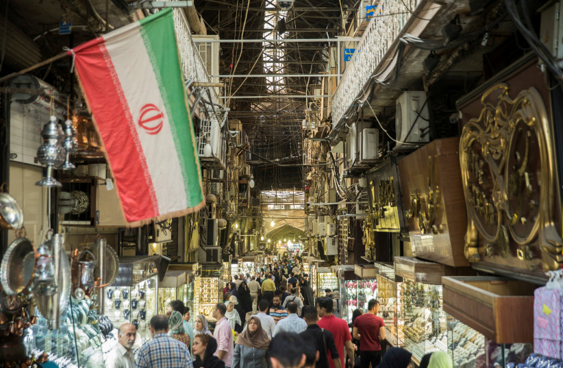 People shop at the Grand Bazaar in the center of Tehran, Iran, August 2, 2017 (photo credit: NAZANIN TABATABAEE YAZDI/ TIMA VIA REUTERS)