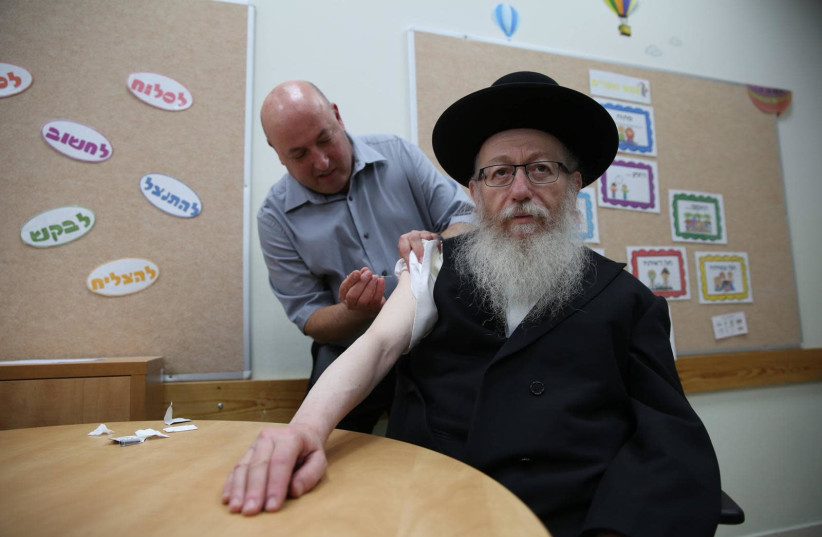 Health Minister Yakov Litzman  received the annual flu shot by Prof. Itamar Grotto in a school in Tel Aviv in October 18, 2018 (photo credit: HEALTH MINISTRY)