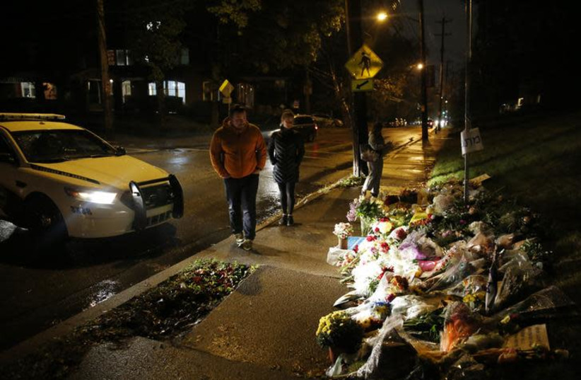 Mourners visit a makeshift memorial outside the Tree of Life synagogue, a day after 11 Jewish worshippers were shot dead in Pittsburgh, Pennsylvania, U.S., October 28, 2018 (photo credit: REUTERS/CATHAL MCNAUGHTON)
