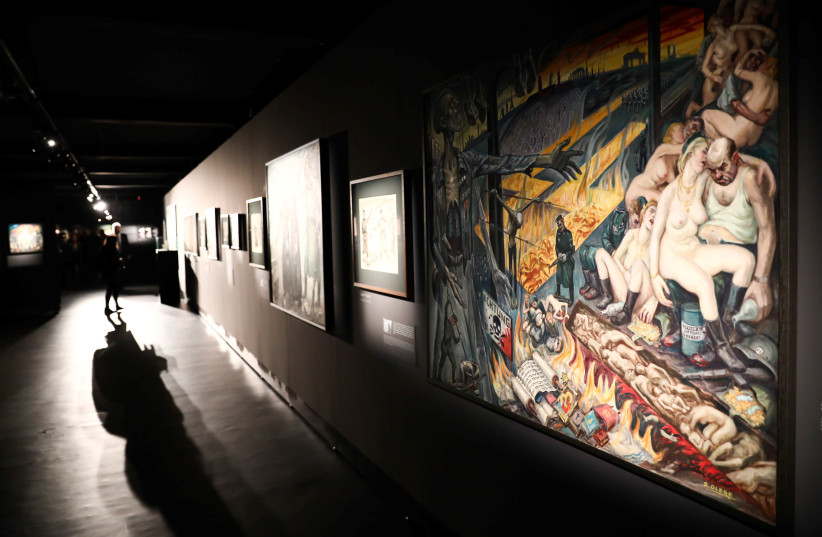 Paintings are pictured during the opening of an exhibition featuring works by David Olere, a prisoner in Auschwitz concentration camp. (photo credit: JAKUB PORZYCKI/AGENCJA GAZETA/REUTERS)