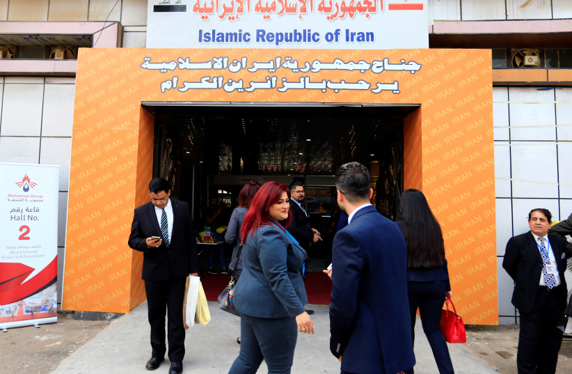 People walk in the entrance of the Iran section of the Baghdad International Fair, in Baghdad, November 10, 2018 (photo credit: THAIER AL-SUDANI/REUTERS)