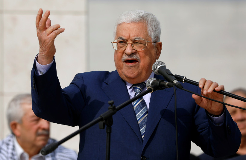 Palestinian President Mahmoud Abbas gestures as he speaks during a ceremony marking the 14th anniversary of the death of late Palestinian leader Yasser Arafat in Ramallah,  November 11, 2018 (photo credit: MOHAMAD TOROKMAN/REUTERS)