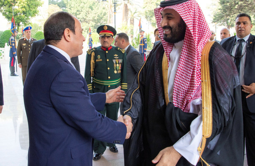 Saudi Arabia's Crown Prince Mohammed bin Salman shakes hands with Egyptian President Abdel Fattah al-Sisi at the Presidential Palace in Cairo, Egypt November 27, 2018 (photo credit: BANDAR ALGALOUD/COURTESY OF SAUDI ROYAL COURT/HANDOUT VIA REUTERS)