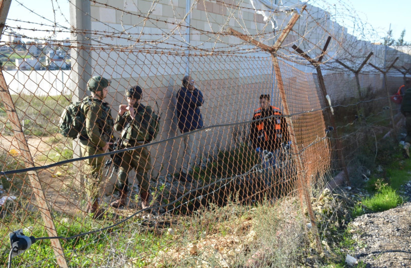 Soldiers and emergency worker gather following clashes between an IDF soldier and a Palestinian who threw a rock at his head  (photo credit: TPS)