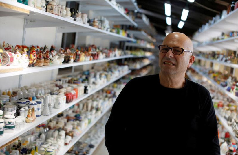 Eitan Bar-on stands next his collection of 37,000 pairs of shakers, displayed in a shack at the backyard of his home in Hadera, Israel December 12, 2018. Picture taken December 12, 2018. (photo credit: REUTERS/NIR ELIAS)
