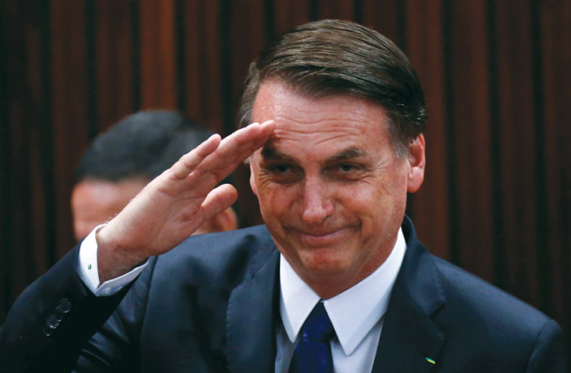 STARTLING SHIFT: Brazil’s president-elect Jair Bolsonaro salutes before receiving confirmation of his victory in the recent election, in Brasilia on December 10. (photo credit: REUTERS)