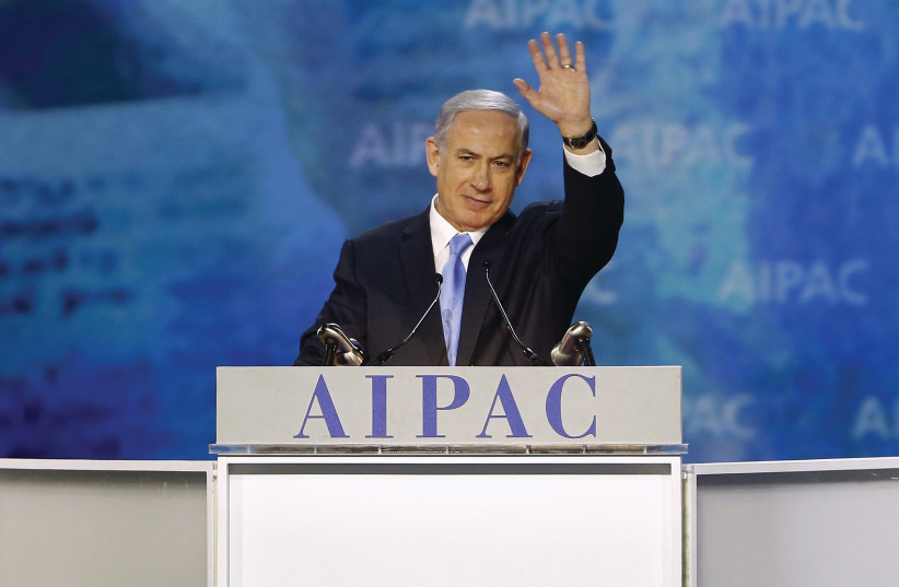 PRIME MINISTER Benjamin Netanyahu waves at the crowd at the AIPAC Policy Conference in 2015 (photo credit: REUTERS)