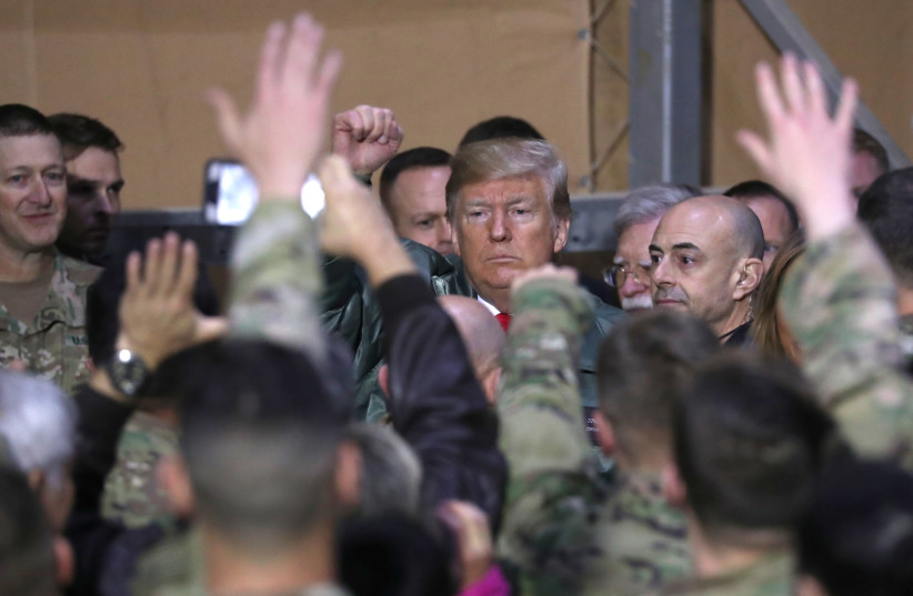 U.S. President Donald Trump delivers remarks to U.S. troops in an unannounced visit to Al Asad Air Base, Iraq December 26, 2018 (photo credit: JONATHAN ERNST / REUTERS)