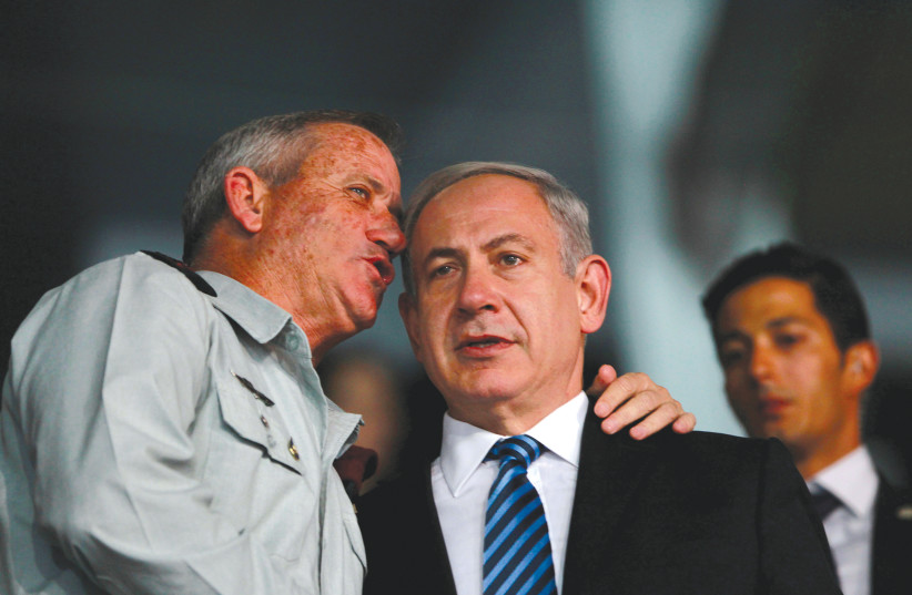 PRIME MINISTER Benjamin Netanyahu listens to then-IDF chief of staff Benny Gantz in 2013.  (photo credit: BAZ RATNER/REUTERS)