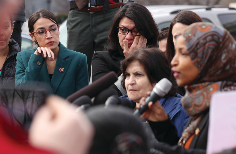 US REPRESENTATIVE Alexandria Ocasio-Cortez and Representative Rashida Tlaib wipe away tears as Representative Ilhan Omar talks about her experience as a refugee earlier this month (photo credit: REUTERS)