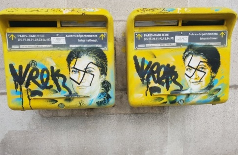 Slurs painted on the memorial art of French street artist Christian Guemy in honor of the late Simone Veiil (photo credit: screenshot)