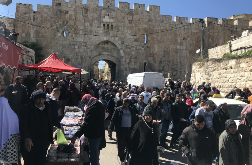Thousands leave Jerusalem’s Lions Gate after prayers Friday (photo credit: SETH J. FRANTZMAN)