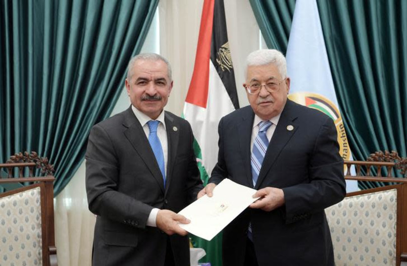 Senior Fatah official Mohammad Shtayyeh receives a designation letter from Palestinian President Mahmoud Abbas to form a new Palestinian government, in Ramallah (photo credit: REUTERS)