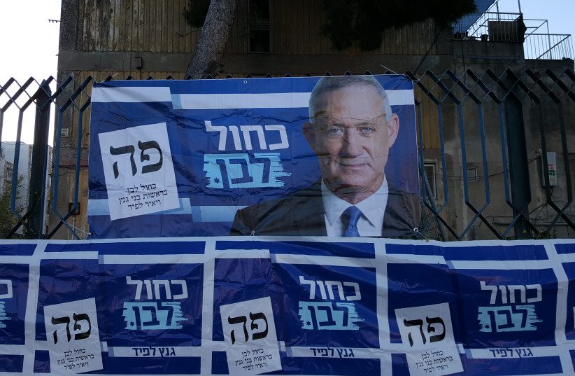 Campaign advertisements for Benny Gantz, chairman of the Blue and White party outside a polling station in Jerusalem, April 9, 2019 (photo credit: BEN BRESKY)