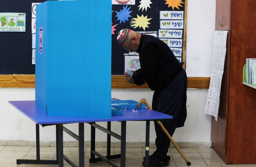 Druze man votes, April 9, 2019 (photo credit: REUTERS/AMMAR AWAD)