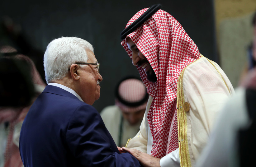 Saudi Arabia's Crown Prince Mohammed bin Salman greets Palestinian President Mahmoud Abbas before the start of the 29th Arab Summit in Dhahran, Saudi Arabia April 15, 2018 (photo credit: HAMAD I MOHAMMED/REUTERS)