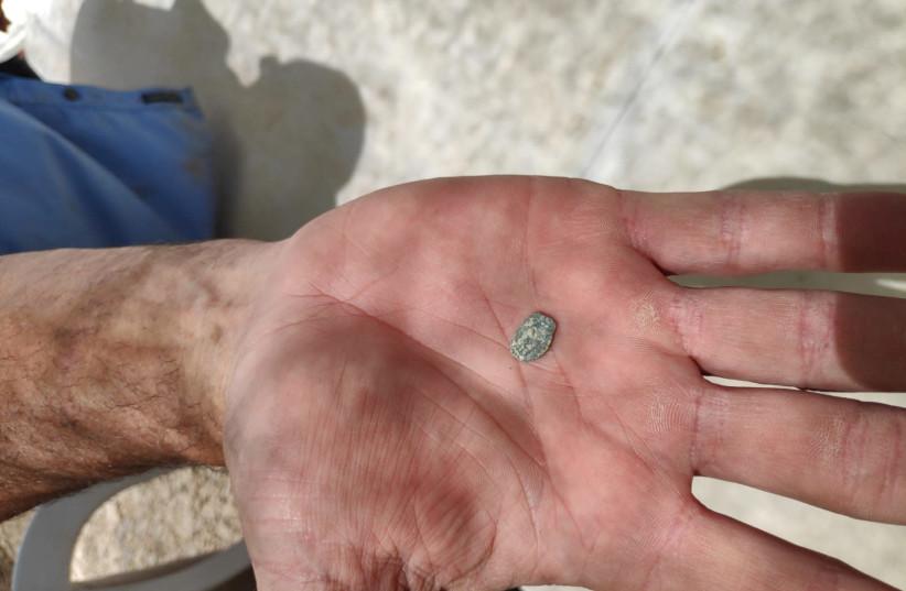 A Hasmonean era coin found at an archaeological excavation in Shiloh, June 2019 (photo credit: BINYAMIN SPOKESPERSON'S UNIT)
