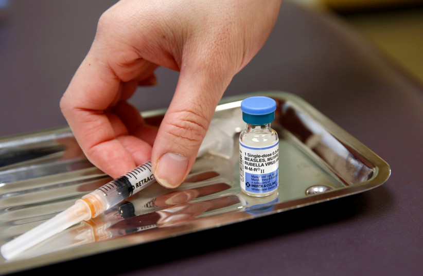 A vial of the measles, mumps, and rubella virus (MMR) vaccine is pictured at the International Community Health Services clinic in Seattle, Washington, U.S., March 20, 2019. Picture taken March 20, 2019 (photo credit: REUTERS/LINDSEY WASSON)