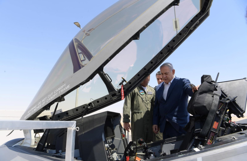Prime Minister Benjamin Netanyahu checks out an F-35 jet (photo credit: AMOS BEN-GERSHOM/GPO)
