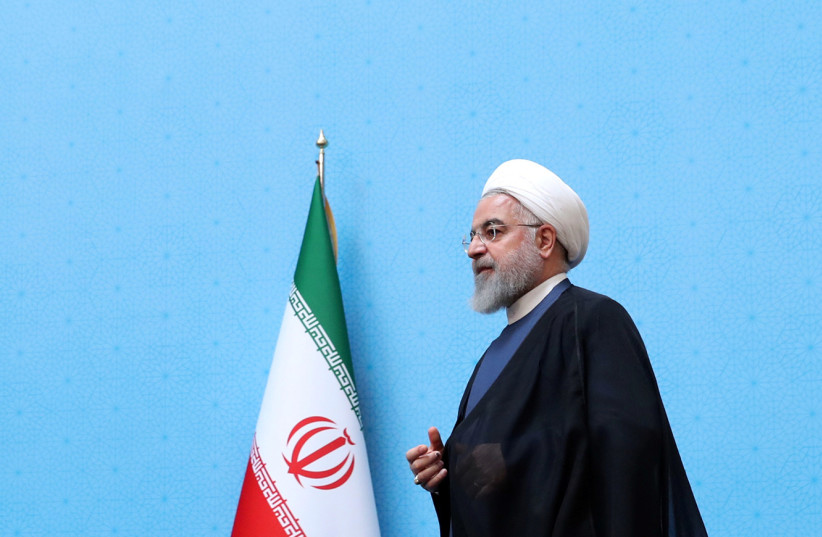 Iranian President Hassan Rouhani walks to deliver a speech during the Conference of Government’s Achievements in Developing Rural Infrastructure in Tehran, Iran, August 26, 2019.  (photo credit: PRESIDENT.IR/HANDOUT VIA REUTERS)