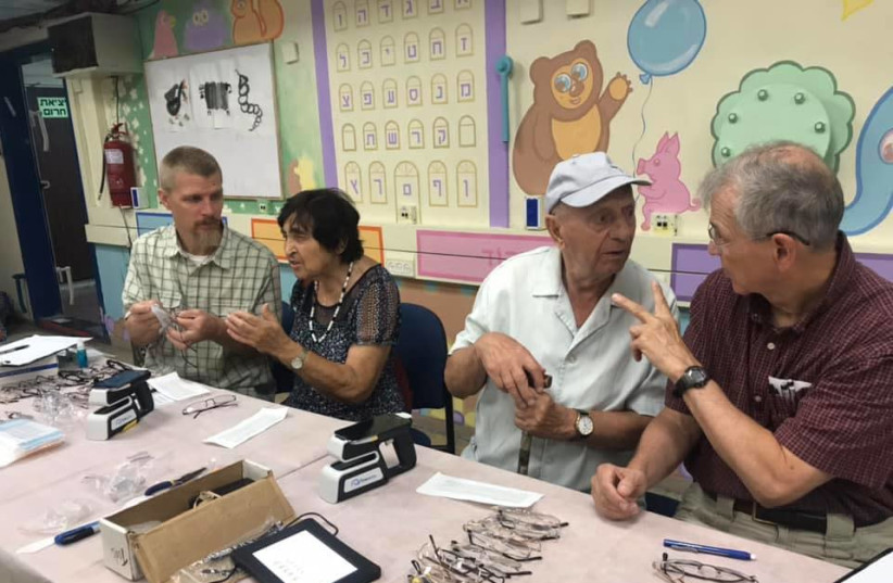Helping Hand Coalition distributes eyeglasses to Holocaust survivors (photo credit: HELPING HAND COALITION)