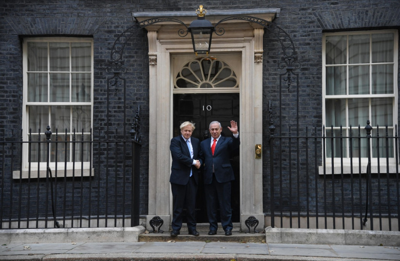 UK Prime Minister Boris Johnson [L] meets Prime Minister Benjamin Netanyahu in London [R]  (photo credit: CHAIM TZACH/GPO)