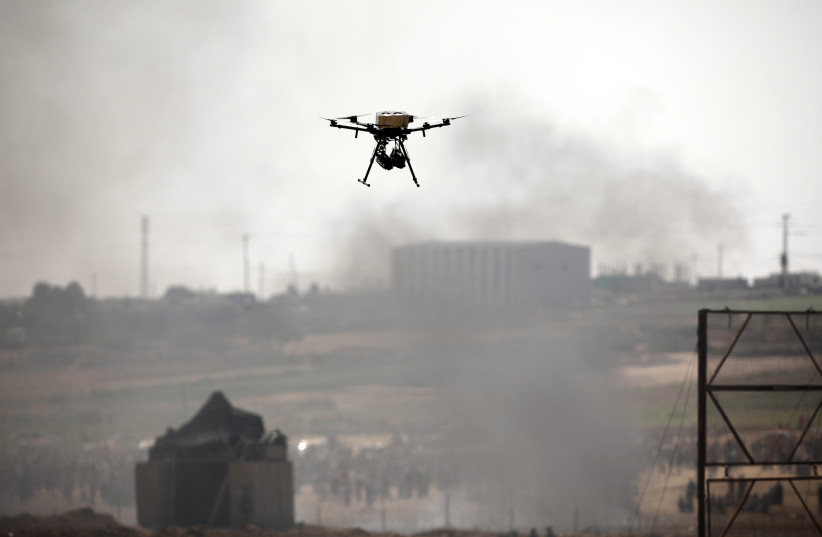 A drone is seen over the border between Israel and Gaza in June (photo credit: AMIR COHEN/REUTERS)