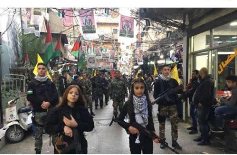 On January 1, 2019 Fatah posted a picture of young girls armed with assault rifles leading a Fatah military procession. The post text: “Fatah’s flowers.” (photo credit: screenshot)