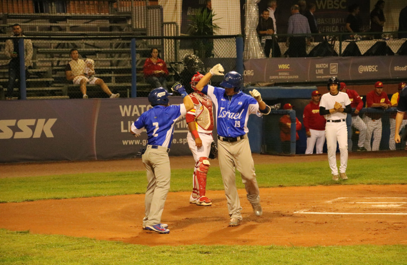 DANNY VALENCIA is congratualted after belting a two-run homer in the first inning of Team Israel’s game against Spain on Wednesday (photo credit: Courtesy)