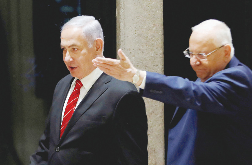 PRESIDENT REUVEN RIVLIN gestures to Prime Minister Benjamin Netanyahu at the President’s Residence on Wednesday. (photo credit: REUTERS)