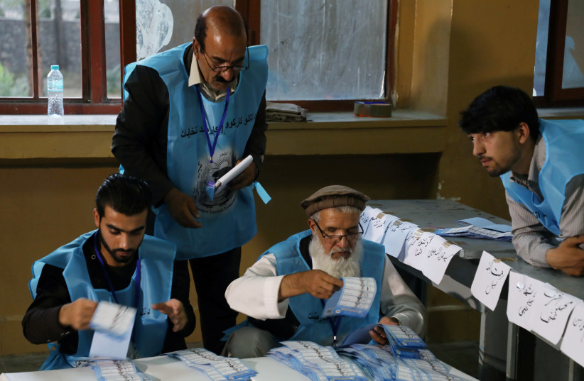 Afghan election commission workers count ballot papers of the presidential election in Kabul, Afghanistan September 28, 2019 (photo credit: REUTERS/OMAR SOBHANI)