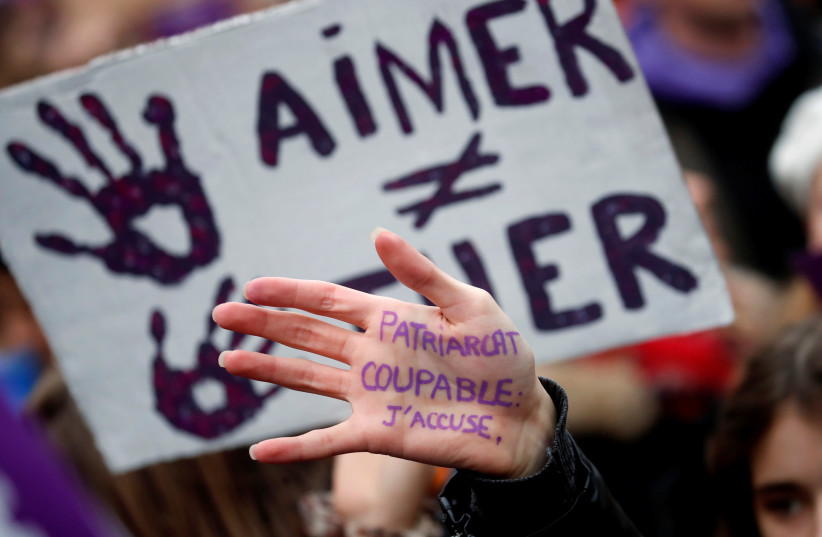 People attend a demonstration to protest femicide and violence against women in Paris (photo credit: REUTERS)