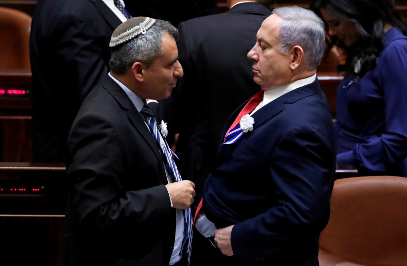 Israeli Prime Minister Benjamin Netanyahu speaks with member of the Knesset for Likud Zeev Elkin as they attend the swearing-in ceremony of the 22nd Knesset, the Israeli parliament, in Jerusalem October 3, 2019. (photo credit: REUTERS/Ronen Zvulun)