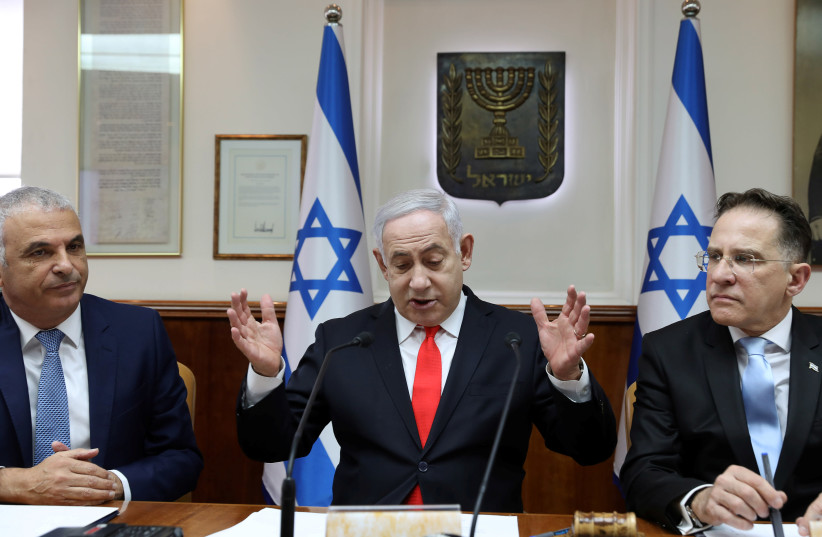 Israeli Prime Minister Benjamin Netanyahu gestures as he chairs the weekly cabinet meeting at his Jerusalem office December 15, 2019 (photo credit: GALI TIBBON POOL/REUTERS)