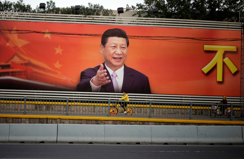A poster with a portrait of Chinese President Xi Jinping is displayed along a street in Shanghai, China, October 24, 2017 (photo credit: ALY SONG/REUTERS)