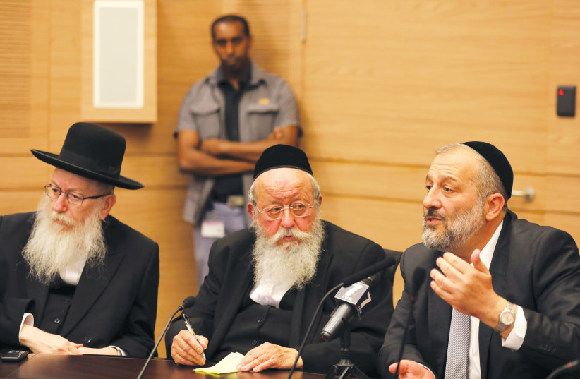 Shas leader Arye Deri (right) and UTJ leader Ya'acov Litzman (far left) attend a meeting in Jerusalem. (photo credit: REUTERS)