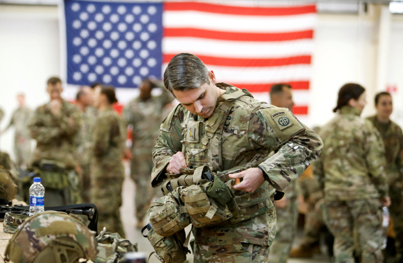 U.S. Army paratroopers from the 82nd Airborne Division prepares before departure to Middle East (photo credit: JONATHAN DRAKE / REUTERS)