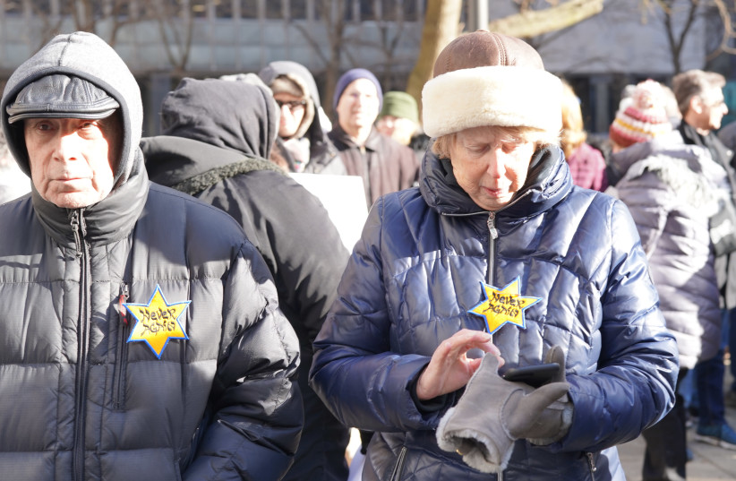 People attend a march in New York against antisemitism wearing yellow stars which read never again, January 5, 2020.  (photo credit: JFNA)
