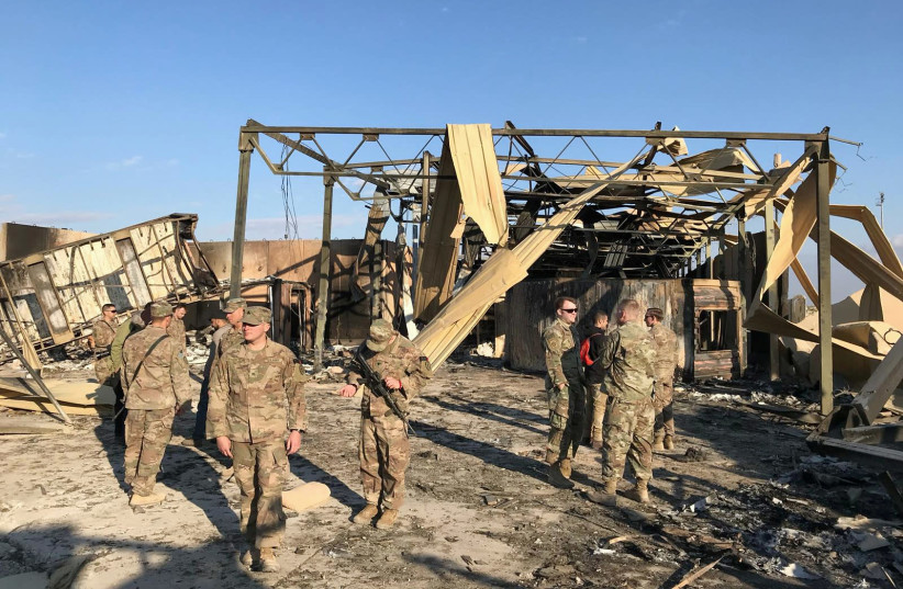 U.S. soldiers inspect the site where an Iranian missile hit at Ain al-Asad air base in Anbar province, Iraq January 13, 2020 (photo credit: REUTERS/JOHN DAVISON)